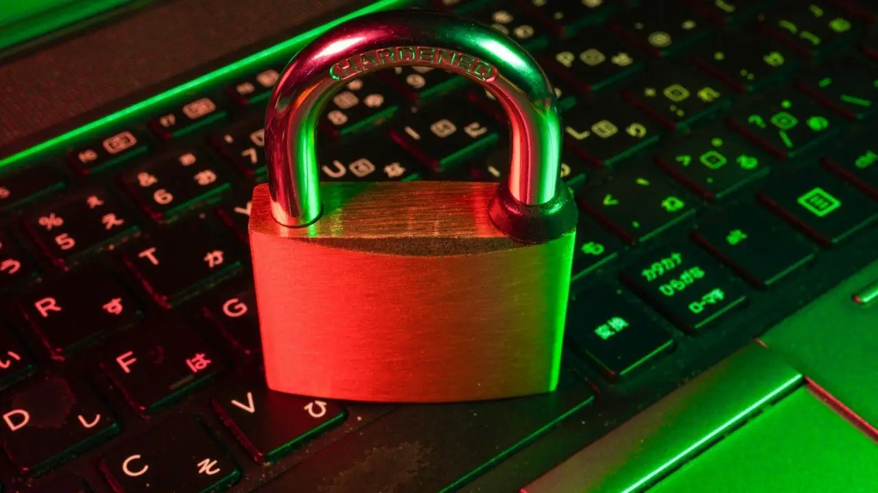 A padlock resting on a glowing laptop keyboard